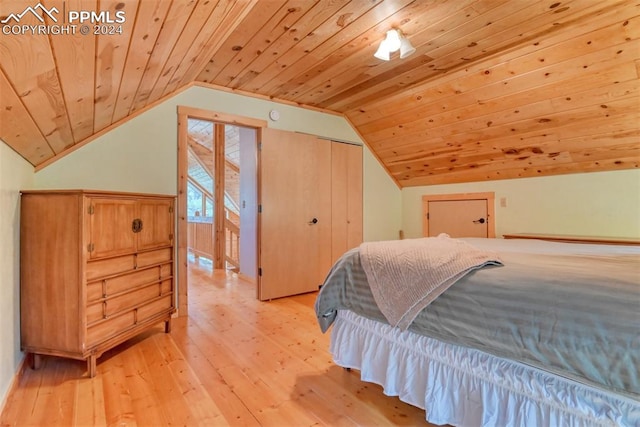 bedroom featuring wood ceiling, vaulted ceiling, light hardwood / wood-style floors, and a closet