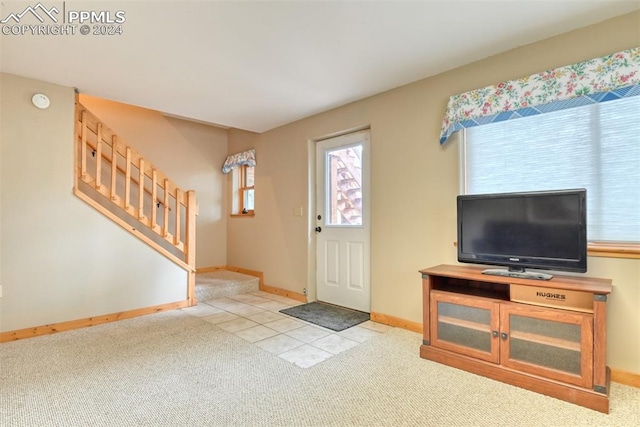 entryway featuring light colored carpet