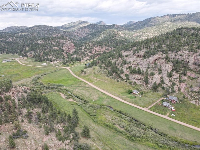 birds eye view of property featuring a mountain view and a rural view