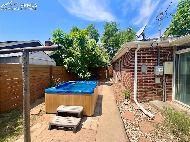 view of patio / terrace with a hot tub