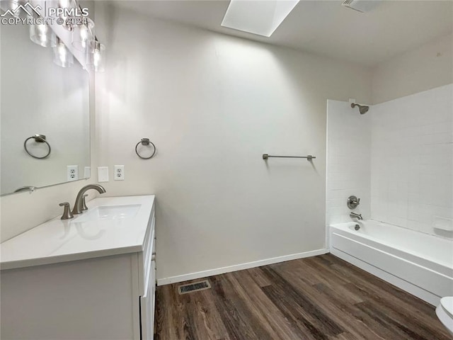 full bathroom featuring vanity, toilet, wood-type flooring, and shower / bath combination