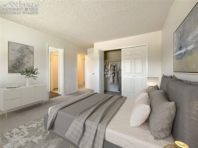 carpeted bedroom with a closet and a textured ceiling