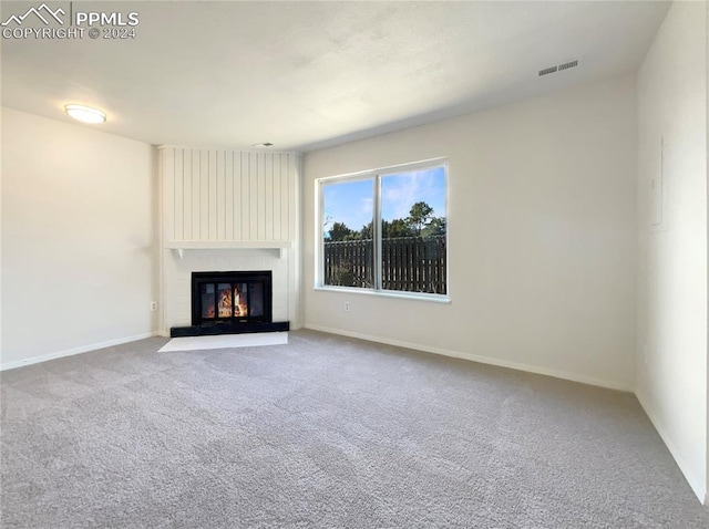 unfurnished living room featuring carpet flooring