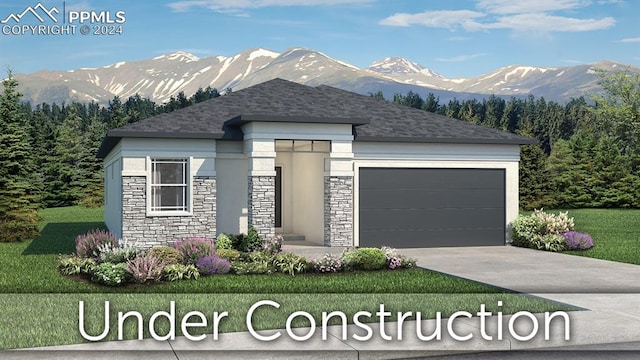 view of front of house with a garage, a front lawn, and a mountain view