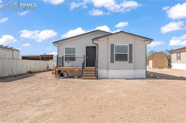 view of front of house featuring a shed