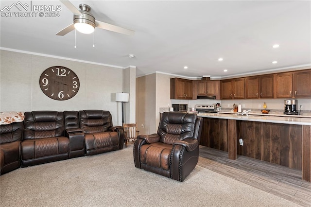 living room featuring ceiling fan, crown molding, and light hardwood / wood-style flooring