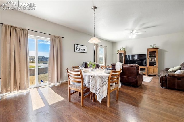 dining area with hardwood / wood-style flooring and ceiling fan