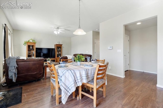 dining space featuring ceiling fan and dark hardwood / wood-style flooring