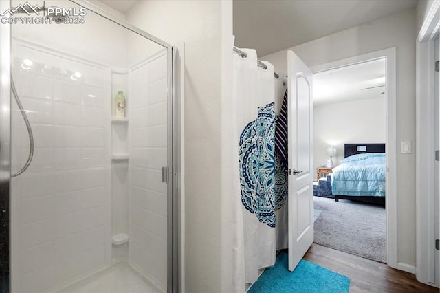 bathroom featuring hardwood / wood-style flooring and walk in shower