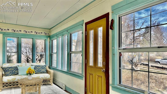 sunroom / solarium featuring baseboard heating