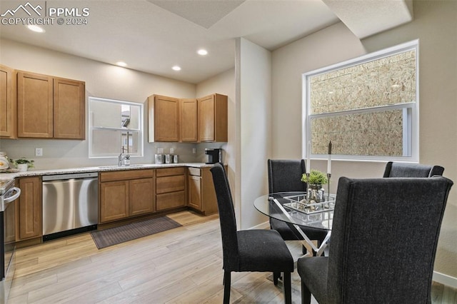 kitchen with light wood-type flooring, sink, and appliances with stainless steel finishes