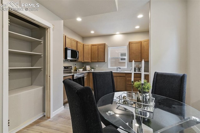 kitchen with light hardwood / wood-style floors, sink, and appliances with stainless steel finishes