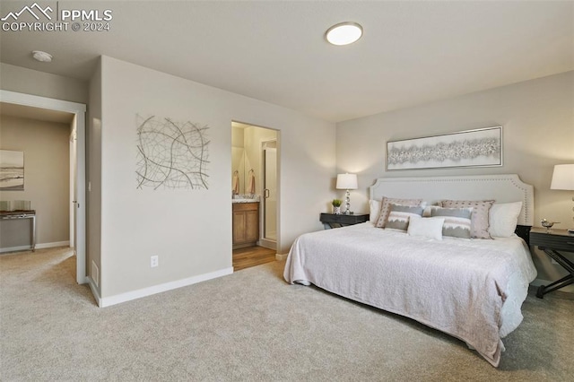 carpeted bedroom featuring connected bathroom