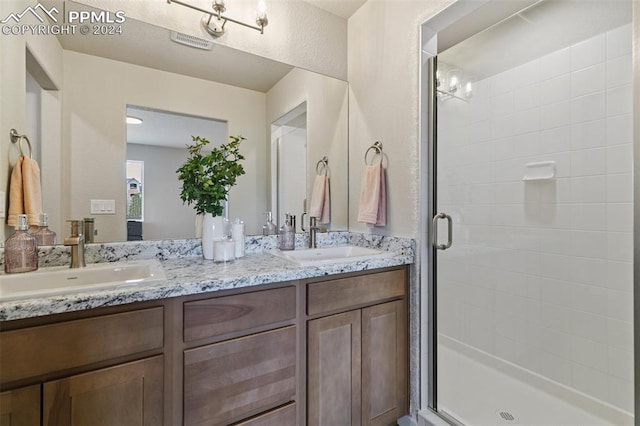 bathroom featuring vanity, a notable chandelier, and walk in shower