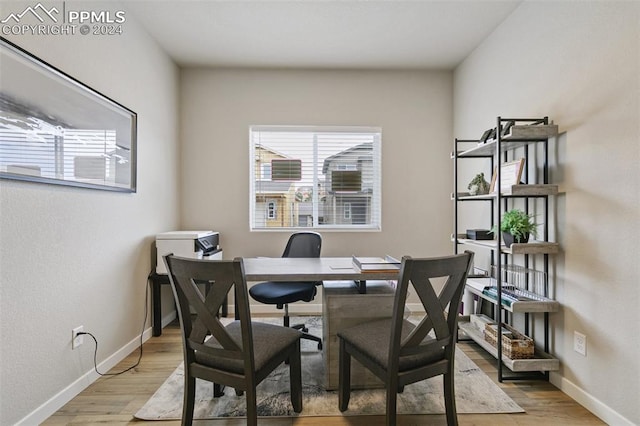 home office with light hardwood / wood-style flooring