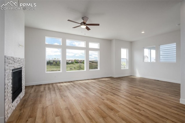 unfurnished living room featuring ceiling fan, light hardwood / wood-style floors, and a wealth of natural light