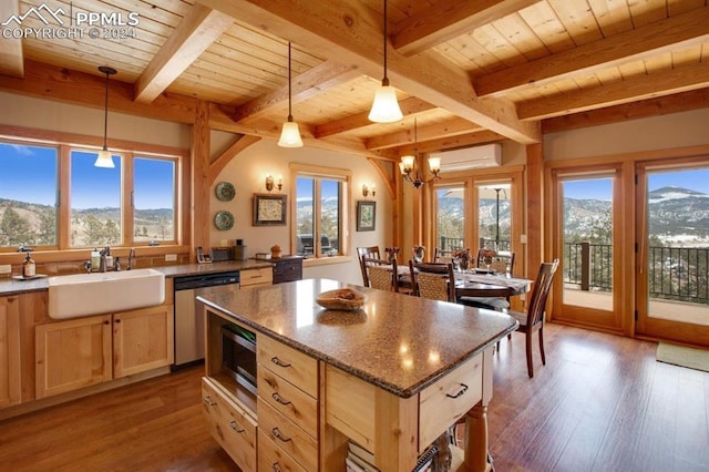 kitchen with hanging light fixtures, a mountain view, dishwasher, and sink