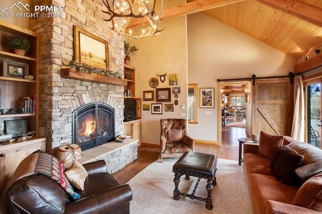 living room featuring beamed ceiling, a barn door, a notable chandelier, wood-type flooring, and wood ceiling