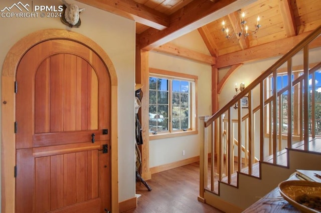 foyer with wooden ceiling, vaulted ceiling with beams, an inviting chandelier, and dark hardwood / wood-style flooring