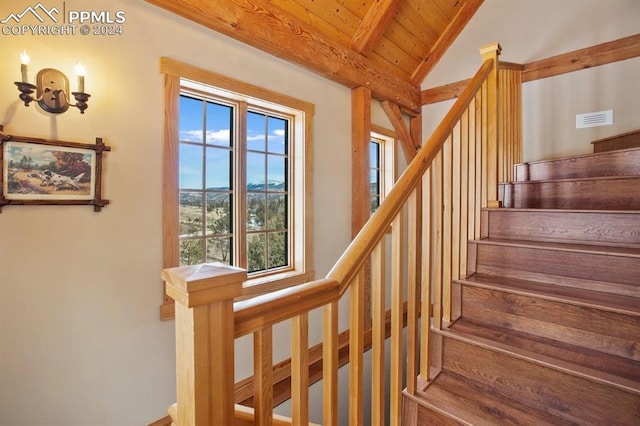 staircase with lofted ceiling with beams, wood ceiling, and wood-type flooring