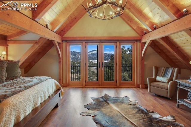 bedroom with vaulted ceiling with beams and access to exterior