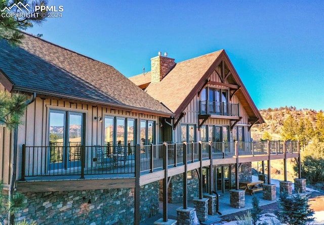 back of house featuring a patio and a balcony