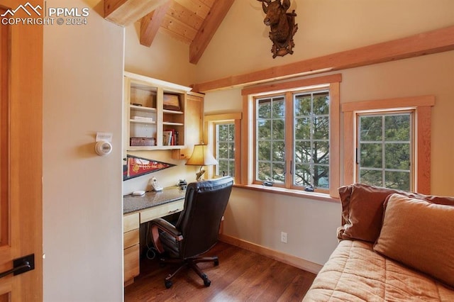 office space with a healthy amount of sunlight, vaulted ceiling with beams, and dark wood-type flooring