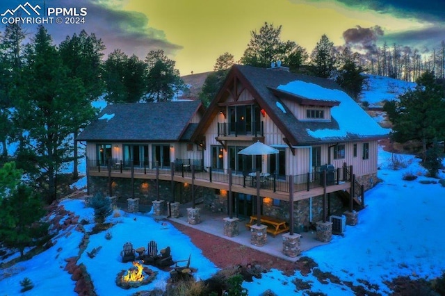 view of front of property featuring a patio and a balcony