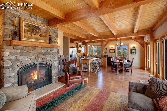 living room with beam ceiling, a fireplace, and light wood-type flooring