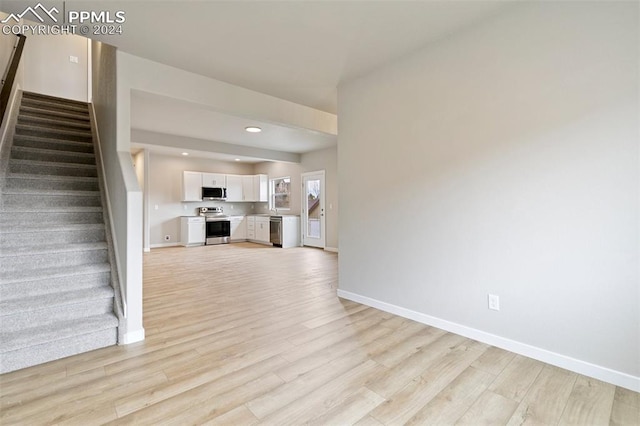 unfurnished living room featuring light hardwood / wood-style flooring