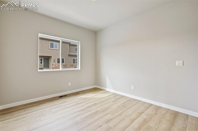 empty room with light hardwood / wood-style floors