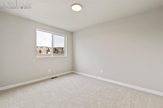 unfurnished room featuring carpet flooring