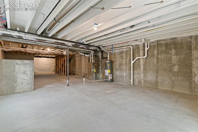 basement featuring gas water heater and heating unit