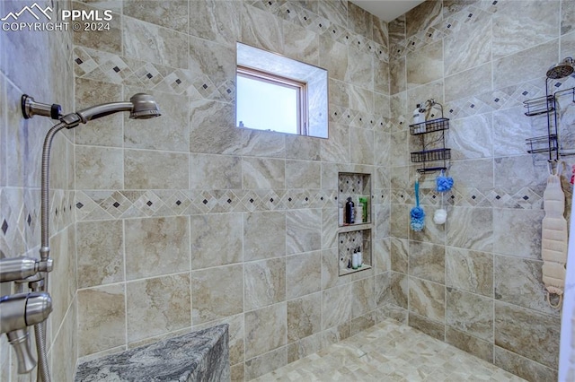 bathroom with tiled shower