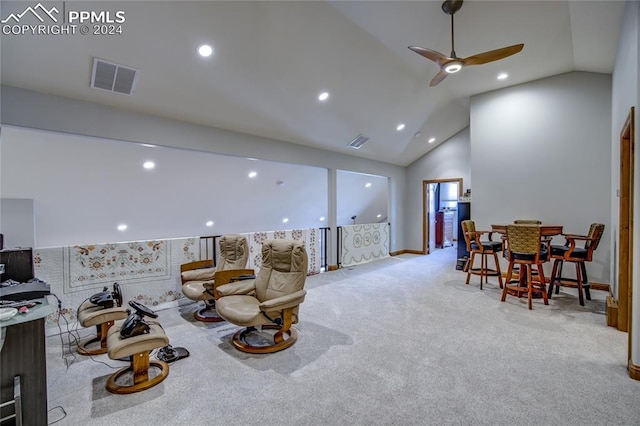 sitting room featuring light carpet, ceiling fan, and vaulted ceiling