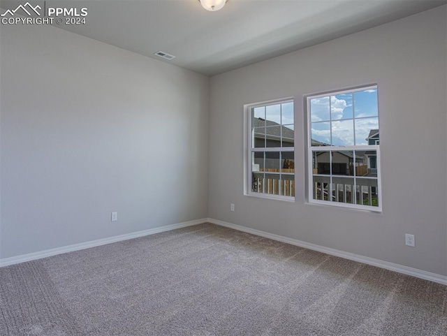 empty room featuring light carpet