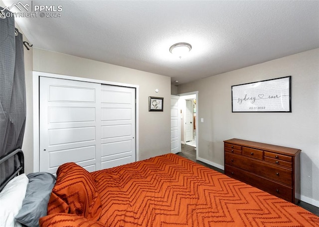 bedroom featuring a closet and dark wood-type flooring