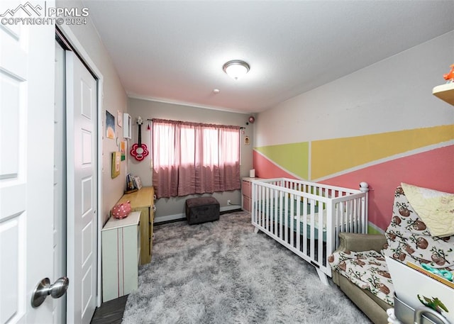 bedroom with a nursery area, vaulted ceiling, and light carpet