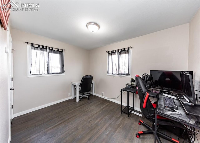 office area with a healthy amount of sunlight and dark hardwood / wood-style flooring