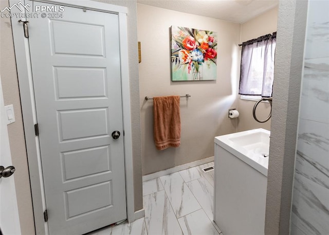 bathroom with tile flooring and vanity