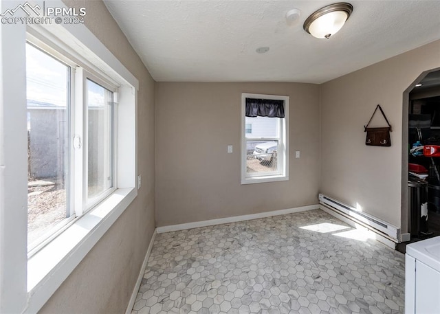 empty room featuring a baseboard radiator and light tile floors