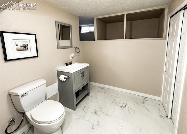 bathroom featuring toilet, tile floors, a textured ceiling, and vanity