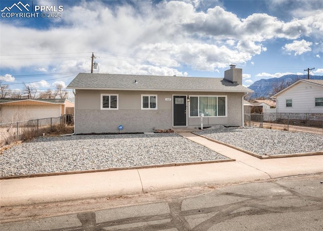 ranch-style home with a mountain view and a patio