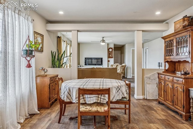 dining area with hardwood / wood-style floors and ceiling fan