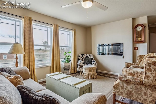 living room featuring a wealth of natural light and ceiling fan