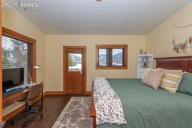 bedroom with dark hardwood / wood-style flooring