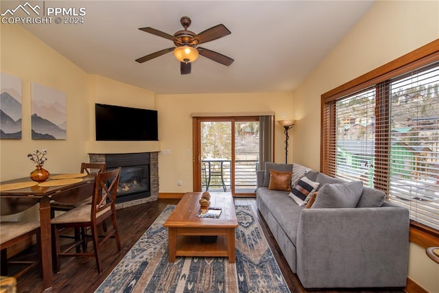 living room with ceiling fan, dark hardwood / wood-style floors, and a fireplace