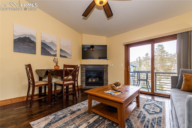 living room with ceiling fan, dark hardwood / wood-style floors, and a fireplace