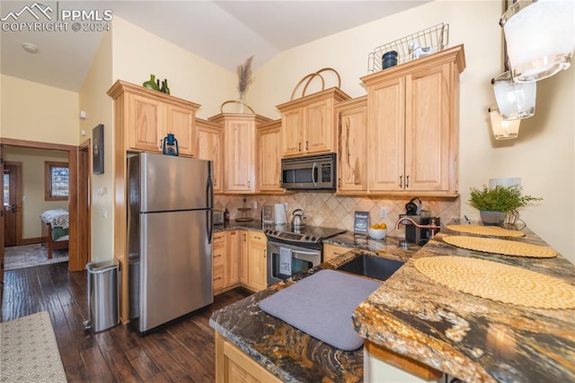 kitchen featuring dark wood-type flooring, stone countertops, appliances with stainless steel finishes, light brown cabinets, and tasteful backsplash