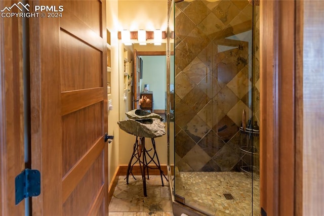 bathroom featuring an enclosed shower and tile floors